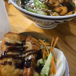 Katsu bao bun in front & jumbo shrimp soup noodles in the back Katsu bao bun in front & jumbo shrimp soup noodles in the back
