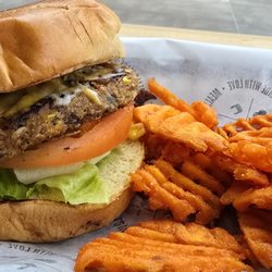 Clean Eatz - Vegetarian black bean burger with mixed shredded cheeses substituted for American Cheese slice, served with sweet potato fries