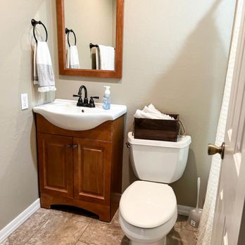 Ron Perkins construction. - a bathroom with a toilet, sink, and mirror - General Contractors Near Me - Cincinnati, Ohio Ron Perkins construction. - a bathroom with a toilet, sink, and mirror - General Contractors Near Me - Cincinnati, Ohio