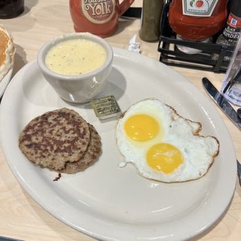 The Toasted Yolk Cafe - Turkey sausage, cheese, grits, and two sunny side up (Two Eggs & A Cake) - Breakfast & Brunch Near Me - Germantown, Tennessee