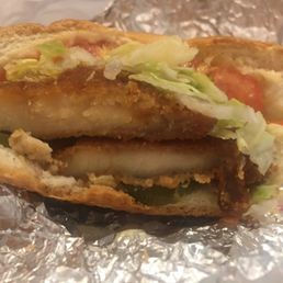 a chicken sandwich with lettuce and tomatoes a chicken sandwich with lettuce and tomatoes
