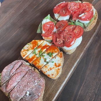 Postino Cinco Ranch - A dozen different bruschetta toppings, mix and match. Here: mozzarella/basil/tomato, goat cheese with pepper jelly, and salami pesto. - Wine Bars Near Me - Katy, Texas Postino Cinco Ranch - A dozen different bruschetta toppings, mix and match. Here: mozzarella/basil/tomato, goat cheese with pepper jelly, and salami pesto. - Wine Bars Near Me - Katy, Texas