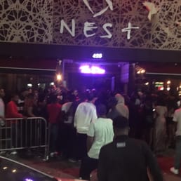 a crowd of people standing outside of a building