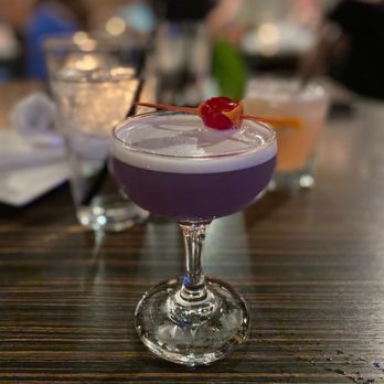 One Eleven Grill - a purple cocktail with a cherry garnish - Wine Bars Near Me - Red Deer, Alberta One Eleven Grill - a purple cocktail with a cherry garnish - Wine Bars Near Me - Red Deer, Alberta