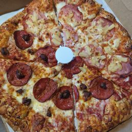 Half Hawaiian and half pepperoni and sausage pizza. Half Hawaiian and half pepperoni and sausage pizza.