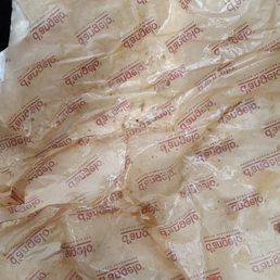a sandwich wrapped in plastic wrap a sandwich wrapped in plastic wrap
