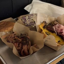 Frozen Smoke BBQ - Left back corner is Hawaiian bun, right back corner is coleslaw. Left front is pulled pork and right front is BBQ Brisket Smash (burger)