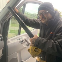 National Auto Glass - Jason has the portable vacuum getting any extra glass from the workspace.