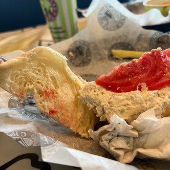 Chicken Salad Chick - a half eaten sandwich with ketchup - Sandwiches Near Me - Hurst, Texas