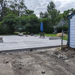 K&K Concrete - Garage pad, several wks later.  Looks great.  K&K  laid grass seed where hay stack is.   With watering the grass is growing in nicely.