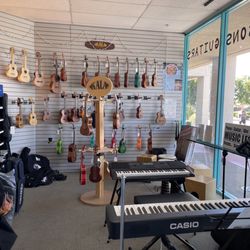 Music Central - Inside: wall of ukuleles with keyboards in front