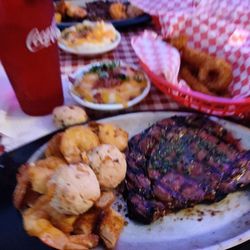 Surf & Turf Cafe - Tender juicy ribeye, jumbo fried shrimp, onion rings, loaded mashed potatoes.
