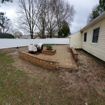 Darnell Landscaping - Paved patio area, wood burning firepit, wall seating with embedded lights that are timed, and a pad area to install a hot tub. - Landscaping Near Me - Hampton, Virginia Darnell Landscaping - Paved patio area, wood burning firepit, wall seating with embedded lights that are timed, and a pad area to install a hot tub. - Landscaping Near Me - Hampton, Virginia