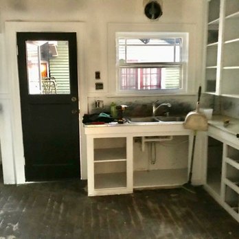 Henry Hardwood Floor Service - Before - kitchen floor covered in black glue crud - Flooring Near Me - Seattle, Washington