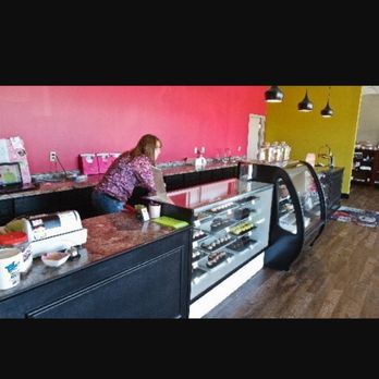 Gourmet cupcake shoppe - a woman sitting at the counter - Bakeries Near Me - Bay City, Michigan Gourmet cupcake shoppe - a woman sitting at the counter - Bakeries Near Me - Bay City, Michigan