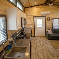 Cullman Campground - Living area of our Peaceful Cabin tiny home rental with full kitchen