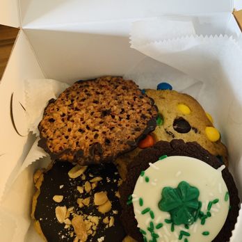 Cookie Time Bakery - Peanut butter, m&m, white chocolate shamrock - A box contains various cookies, such as oatmeal raisin, chocolate-covered, and decorated holiday cookies with sprinkles and shamrocks. - Bakeries Near Me - Arlington, Massachusetts