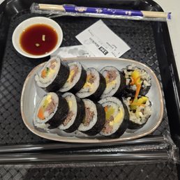 Beef kimbap with side of dipping sauce Beef kimbap with side of dipping sauce