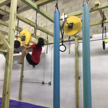 Dragon Fit Ninja Warrior - 14 year old practicing on the flywheels - Circuit Training Gyms Near Me - Spring Hill, Florida