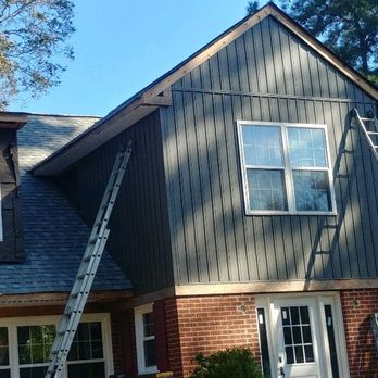 Pro Construction - Board and Batton Vinyl Siding, sofit, pvc metal trim wrap and gutter install in progress. - General Contractors Near Me