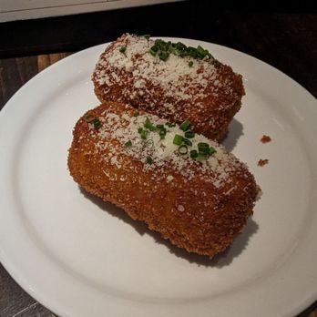 Bar Notte - two pieces of fried chicken on a plate - Cocktail Bars Near Me - Toronto, Ontario