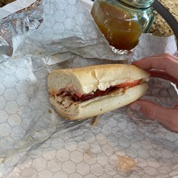 a person holding a sandwich a person holding a sandwich