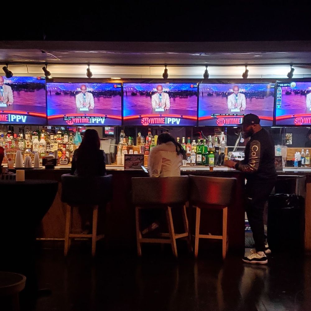 The New 5 Mile House - a bar with people sitting at the bar - New American Near Me - Baltimore, Maryland