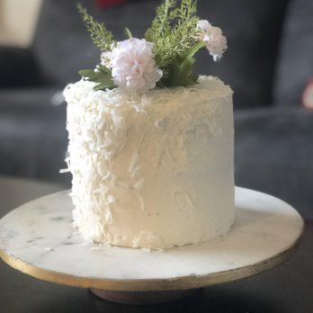 Tastefully Sweet Confections - a white cake on a plate - Desserts Near Me Tastefully Sweet Confections - a white cake on a plate - Desserts Near Me