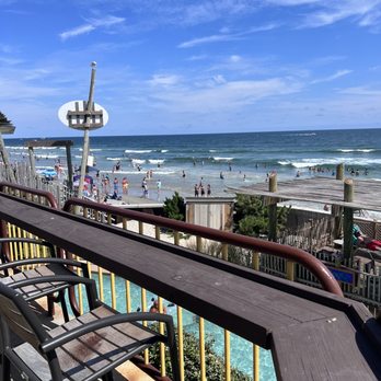 Stubborn Brothers - a view of the beach from a balcony - New American Near Me - North Wildwood, New Jersey Stubborn Brothers - a view of the beach from a balcony - New American Near Me - North Wildwood, New Jersey