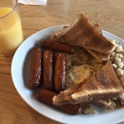 Tania's Restaurant - My meal, orange juice to drink.  Two eggs, over hard.  Whole wheat toast, and five sausages!