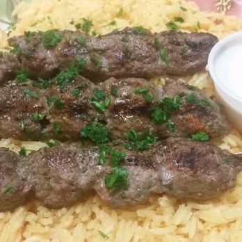 Mr. Shawarma & Grill - Kufta kebab. Beef and lamb. Deliciously laid out on top of pilaf rice with a side of sauce. - Mediterranean Near Me - Fairborn, Ohio Mr. Shawarma & Grill - Kufta kebab. Beef and lamb. Deliciously laid out on top of pilaf rice with a side of sauce. - Mediterranean Near Me - Fairborn, Ohio