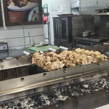 Ilios Crafted Greek - Lamb skewers cooking - Greek Near Me - Charlotte, North Carolina