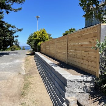 Pro Landscaping - a block retaining wall along the side of a road - Landscaping Near Me - Tacoma, Washington Pro Landscaping - a block retaining wall along the side of a road - Landscaping Near Me - Tacoma, Washington