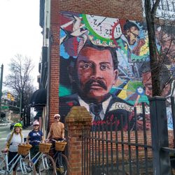 Basket & Bike - Bikes in front of Waller Jeweler mural by artist Ed Trask on Quirk Street Art Tour.