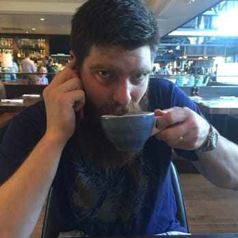 The Henry - Bearded man with a delicious Cuppa Joe. - New American Near Me - Phoenix, Arizona