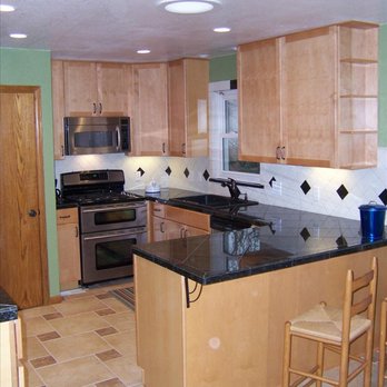 Summit Custom Builders - a kitchen with a center island - General Contractors Near Me - Denver, Colorado