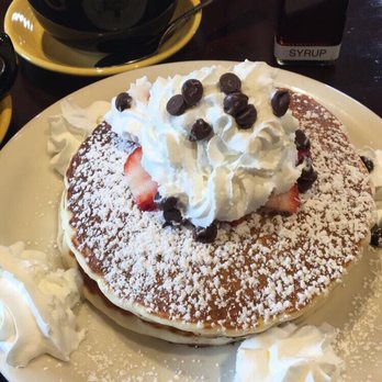 Wildflower Cafe - Strawberries Delight Pancakes and a cappuccino in the back - Breakfast & Brunch Near Me - Redondo Beach, California Wildflower Cafe - Strawberries Delight Pancakes and a cappuccino in the back - Breakfast & Brunch Near Me - Redondo Beach, California