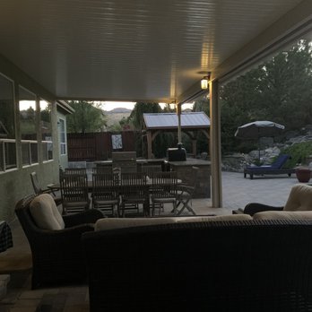 Sierra Nevada Builders - a covered patio with furniture - General Contractors Near Me