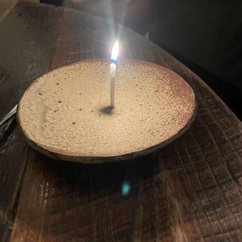 Husk - Single candle on plate - Southern Near Me - Nashville, Tennessee Husk - Single candle on plate - Southern Near Me - Nashville, Tennessee