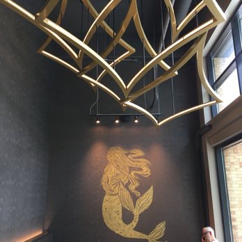 Starbucks - a man sitting at a table in a coffee shop - Coffee & Tea Near Me - Chicago, Illinois