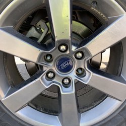 Lyle's Discount Tires - Picture showing missing lug nuts and damage to rim of patched tire. Remaining lug nuts are rounded off or close to it.