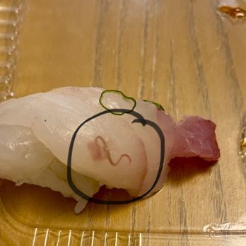 Yirasai Sushi & Cafe - Piece of white fish sushi with a worm - Sushi Bars Near Me - Potomac, Maryland Yirasai Sushi & Cafe - Piece of white fish sushi with a worm - Sushi Bars Near Me - Potomac, Maryland