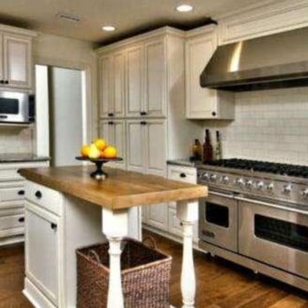 Steve Lawhorn Construction Inc - a kitchen with white cabinets and stainless steel appliances - Flooring Near Me - Anaheim, California Steve Lawhorn Construction Inc - a kitchen with white cabinets and stainless steel appliances - Flooring Near Me - Anaheim, California