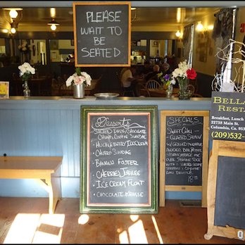 Columbia House Restaurant - As you enter the restaurant, you're greeted with a "Please Wait to be Seated" sign, but a staff member will seat you immediately. - American Near Me - Columbia, California