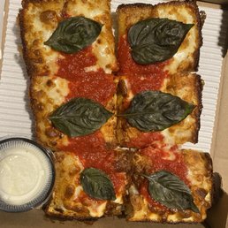 Take out order - Margherita pizza topped basil leaves on each slice. Take out order - Margherita pizza topped basil leaves on each slice.