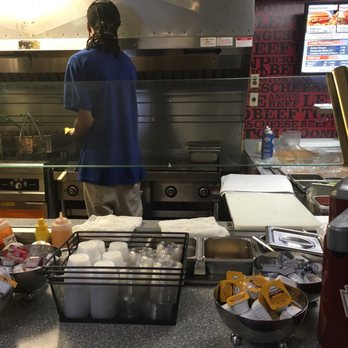 Castle - a man preparing food in a restaurant kitchen - American Near Me - Charlottesville, Virginia Castle - a man preparing food in a restaurant kitchen - American Near Me - Charlottesville, Virginia