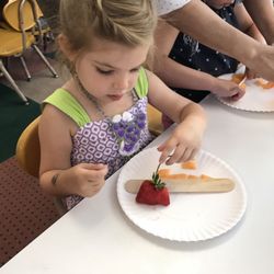 Stepping Stones Learning Center - Making fruit salad.