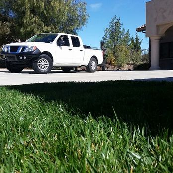 American Yards - a white truck parked in front of a house - Irrigation Near Me