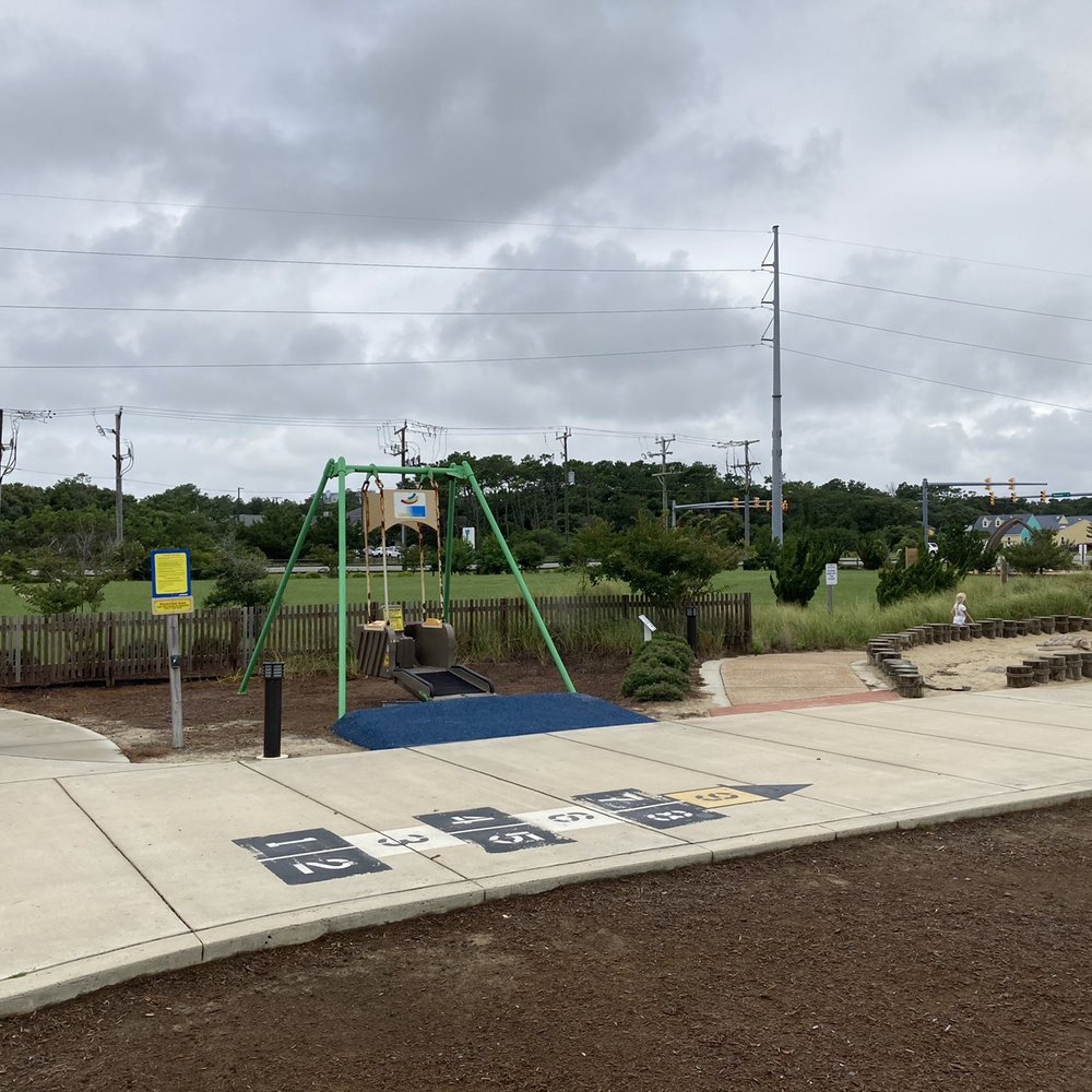 Dowdy Park - Hopscotch in the foreground and an adaptive swing in the background. - Parks Near Me - Nags Head, North Carolina Dowdy Park - Hopscotch in the foreground and an adaptive swing in the background. - Parks Near Me - Nags Head, North Carolina