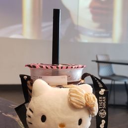 a hello kitty cup with a straw in it a hello kitty cup with a straw in it